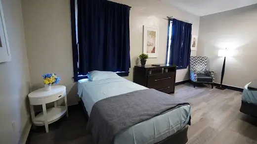 Cozy bedroom with two beds at Unlimited Bounds Human Services detox center in Baltimore.