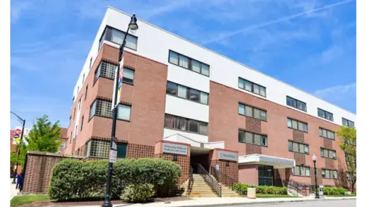 Modern brick building exterior of UMMC MTC Center for Addiction Medicine, a detox center in Baltimore.