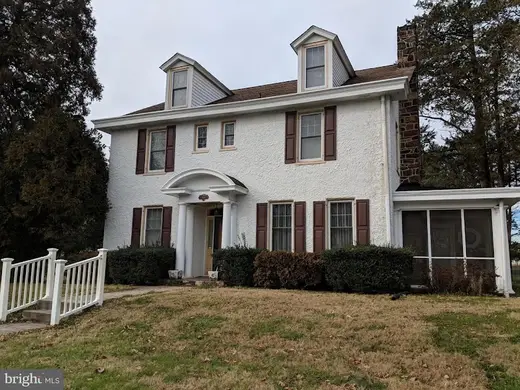 Charming white house exterior of Voices of Hope, Inc., a sober living home in Baltimore.