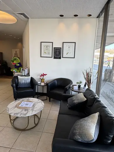 Inviting lounge area with black leather seating at Voices of Hope - Harford, a sober living home in Baltimore.