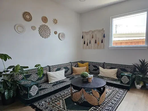 Cozy seating area with decorative wall hangings at Mental Health and SUD Services LLC, a sober living home in Baltimore.