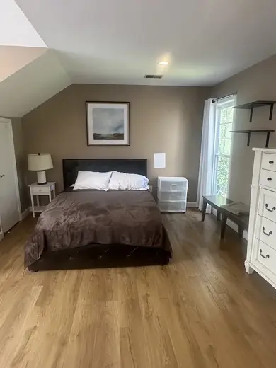 Cozy bedroom with a queen bed at Severn Home, a sober living home in Baltimore.